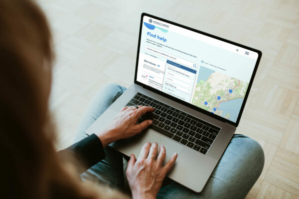 A woman using a laptop with a map on it.