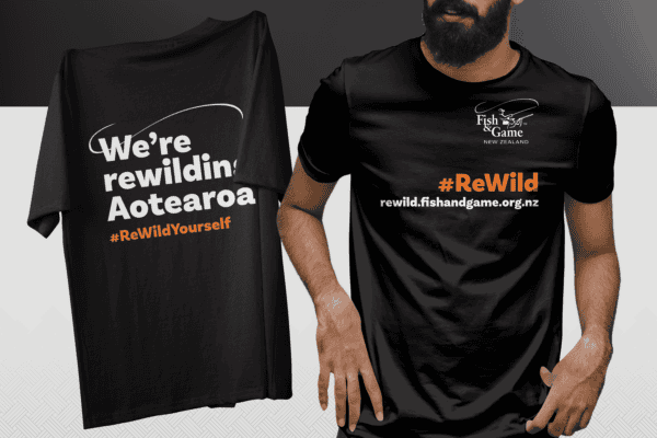 Two black T-shirts with environmental messages: left shirt reads "We're rewilding Aotearoa #ReWildYourself," right shirt has "Fish & Game New Zealand" logo and "#ReWild" slogan with web address.